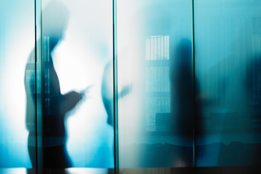 Window reflection of people in a meeting